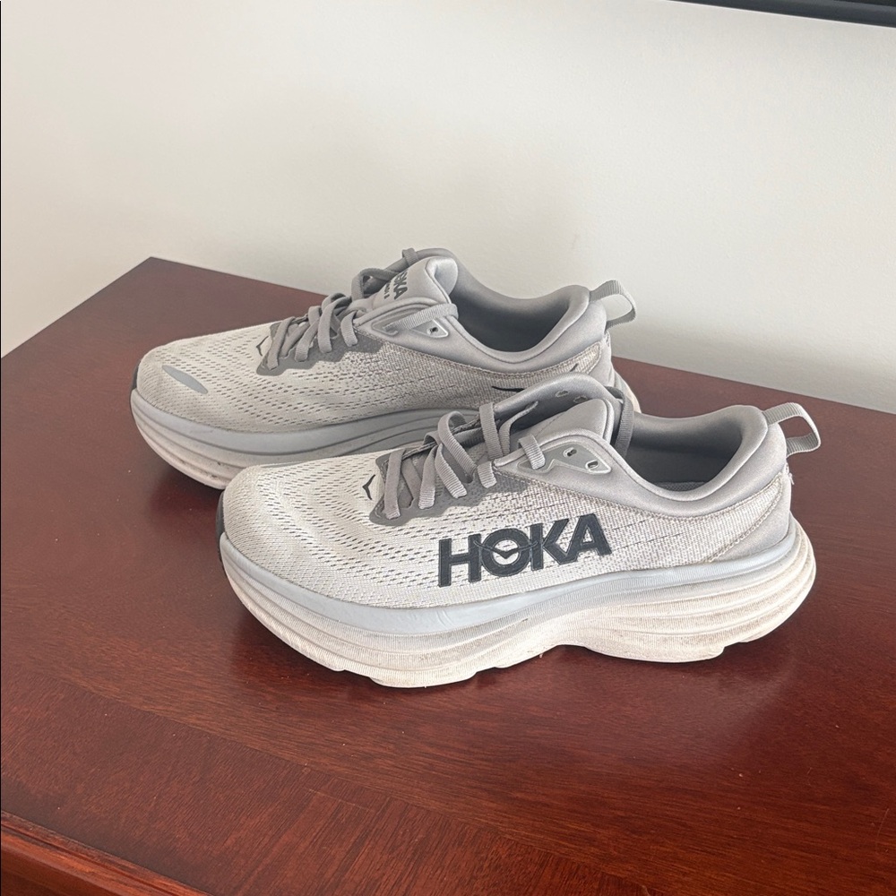 Mens worn HOKA sneaker in size 8